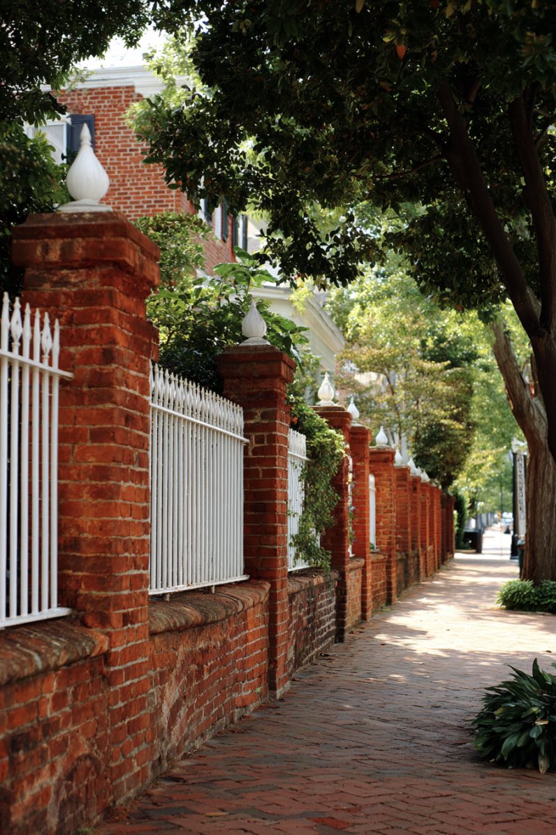 Red Brick Fence with White Metal Railings
