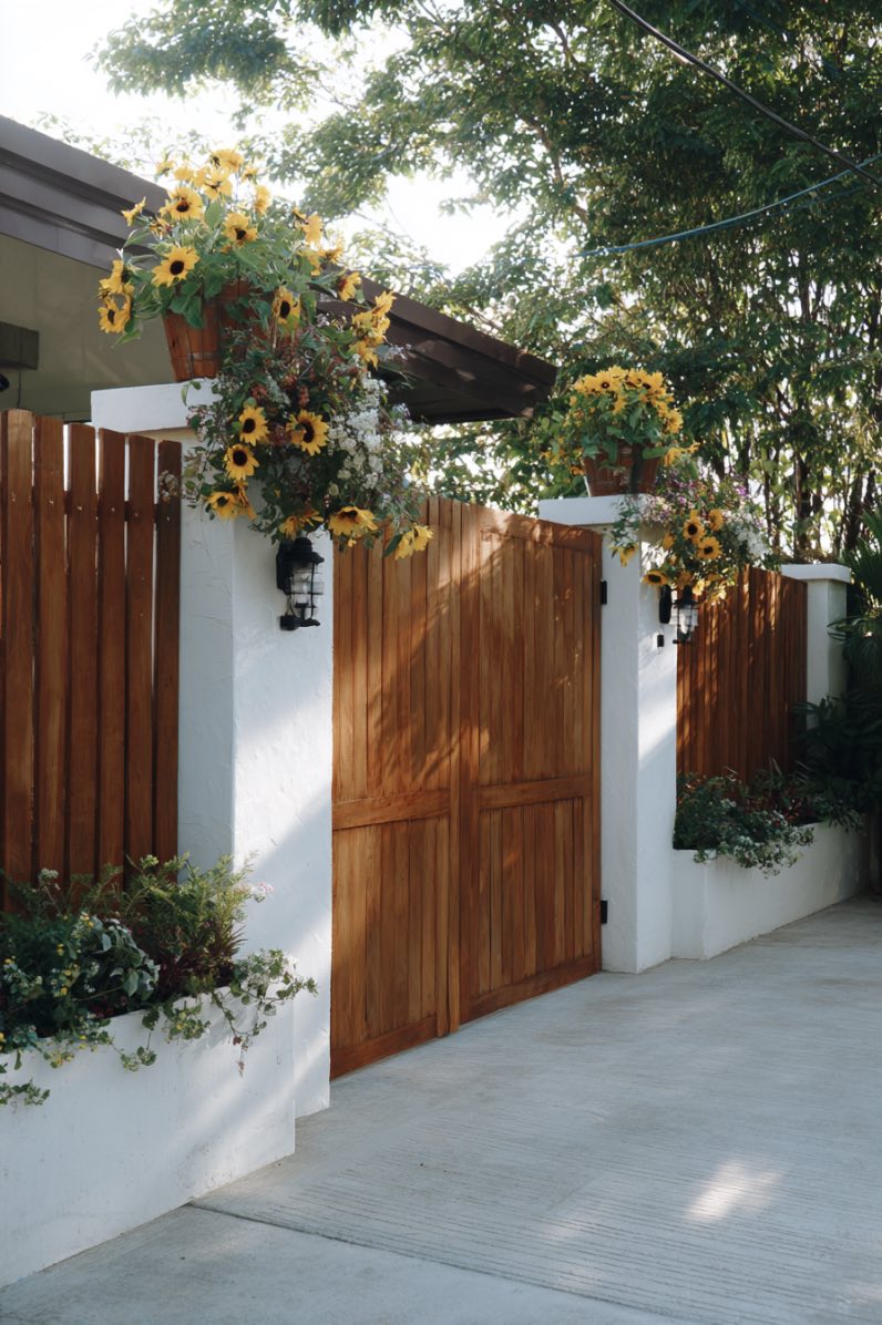 Wooden Slat Fence with Painted Gate and Planters